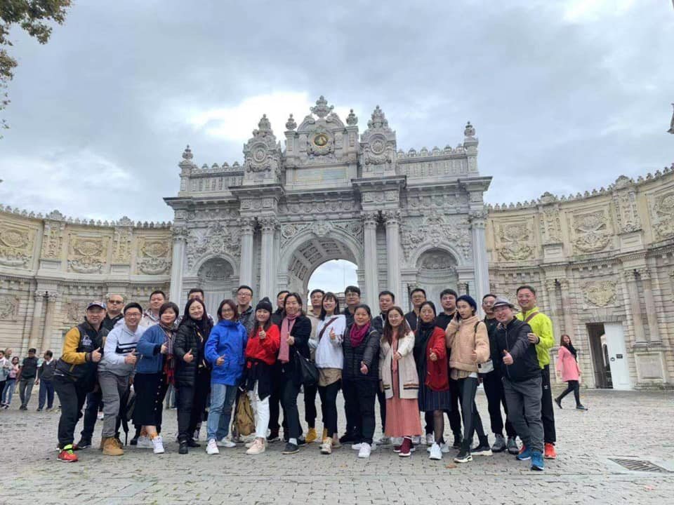 Happy travellers on a private tour at the gate of Dolmabahçe Palace, Istanbul